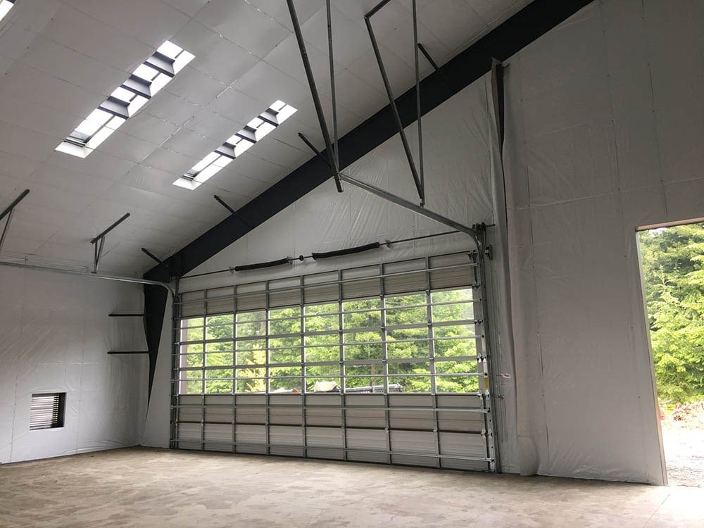 Technician using tools for garage door maintenance in Hilliard