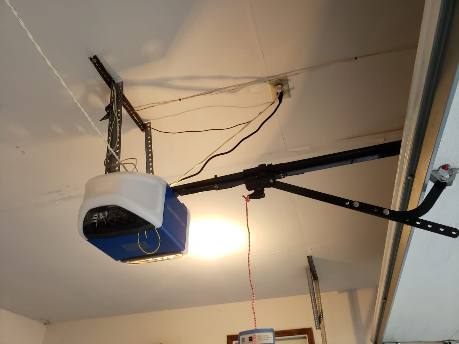 Technician repairing a residential garage door opener mechanism
