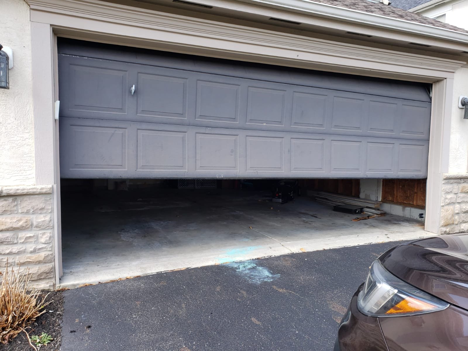 Garage door replacement process with tools and technician ensuring a perfect installation