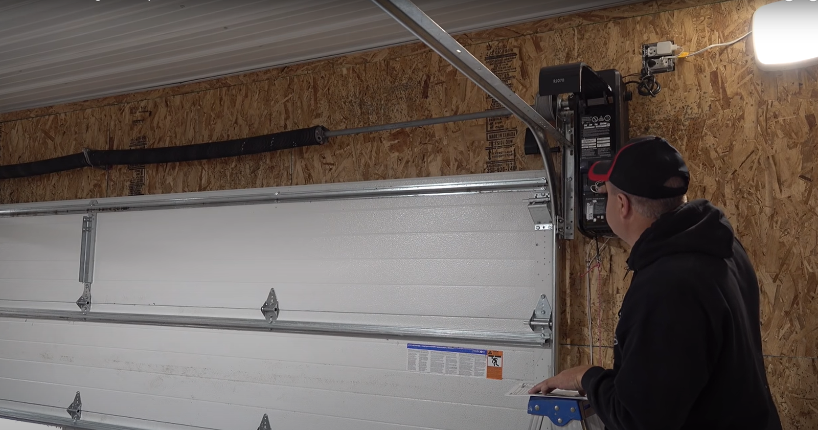 Garage door replacement panels laid out before installation, with durable materials ready for repair.