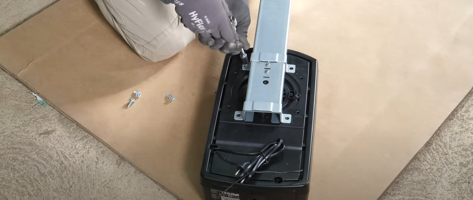Technician repairing a residential garage door opener mechanism.
