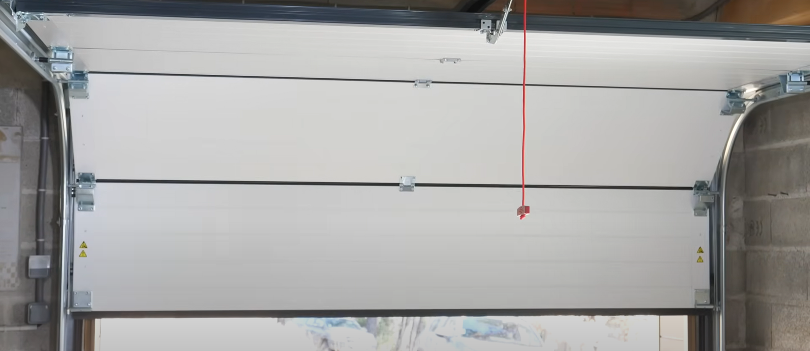 A comparison image of a technician from Hilliard Garage Door Repair conducting a garage door repair on one side and installing a new garage door on the other.